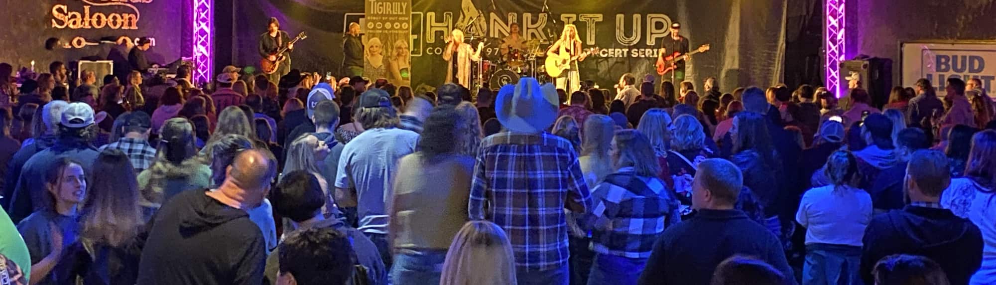 country concert with fans wearing cowboy hats Louisville